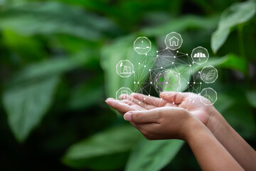 Technology, hand holding with environment Icons over the Network connection on green background.