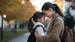 © forenna - heartfelt scene of a young mother and her schoolgirl daughter bonding before class, with the mom gently hugging her daughter and their foreheads touching, illustrating the nurturin