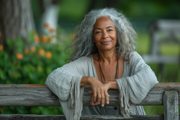 Graceful older woman with silver hair in serene outdoor setting