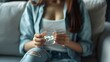 © neirfy - A woman holding various colorful pills in her hands, representing health, treatment, and medication.