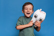 © Anastasia - A smiling boy with healthy teeth holds a plush tooth on a blue background. Oral hygiene. Pediatric dentistry.