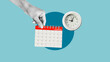 © Andrii - Hand is turning the page of calendar. The date of deadline in calendar and time concept. Important Event in Personal organizer