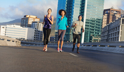 Poster - City, road and friends running together for fitness, training or commitment to healthy body. Morning, exercise and group of people on street for urban workout, outdoor challenge or sports performance