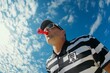 © Olsek - A passionate referee stands under a vast blue sky. He blows a bright red whistle. This image captures the intensity of sports and the role of officiating. Generative AI