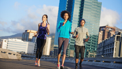 Poster - Man, women and running together in city for fitness, training or commitment to healthy body. Morning, exercise and group of friends on road for urban workout, outdoor challenge or sports performance