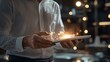 © iamtopkritsada - A businessman interacts with a tablet, showcasing digital sparks of creativity and innovation in a modern, illuminated space.