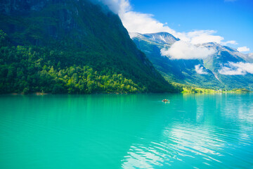 Wall Mural - vacation and travel in summer norway. boat on a mountain lake in a norwegian fjord. nature in fjords