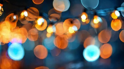 Wall Mural - glowing christmas lights with bokeh effect on dark background. christmas golden light shine particle