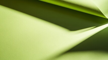 Wall Mural - Bright green textured paper showing soft curves and shadows in natural light during the afternoon