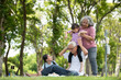 © surachetkhamsuk - Happy Asian family children having fun and playing with her grandparents in the park