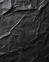 Wall Mural - Crumpled black paper texture with shadows highlighting its intricate folds and creases