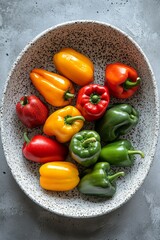 Wall Mural - Fresh variety of colorful bell peppers and herbs arranged on a dark plate