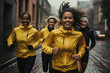 © KirKam - Energetic group of diverse women running through city streets in the rain, showcasing determination and teamwork in urban fitness.