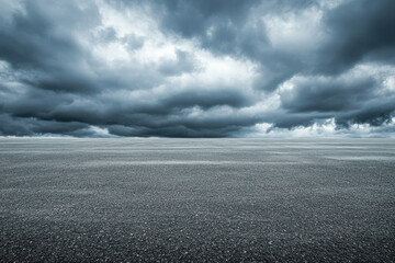 Dark storm clouds gathering over empty asphalt road