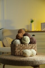 Wall Mural - Wicker basket with colorful yarns and knitting needles on coffee table in cozy room