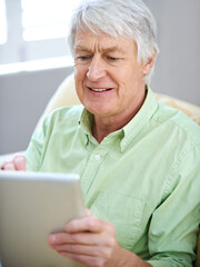 Canvas Print - Tablet, relax and senior man in home on internet for social media, website and online entertainment. Retirement, happy and elderly person on digital tech for search, reading news and connection