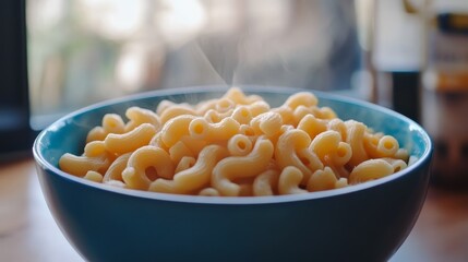 Poster - A close-up shot of a bowl of macaroni pasta, steaming hot and ready to eat. The pasta is cooked to perfection, with a creamy sauce that is just visible.  This image symbolizes comfort food, a warm mea