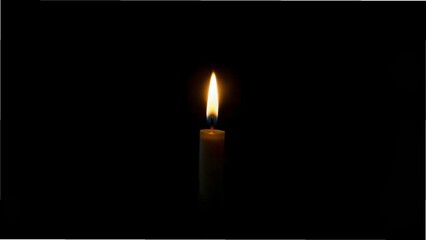 a solitary candle flickers softly, illuminating the darkness around it with a warm, gentle glow