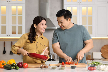 Poster - Happy lovely couple cooking together in kitchen