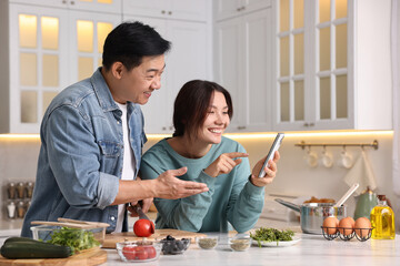 Happy lovely couple cooking together in kitchen