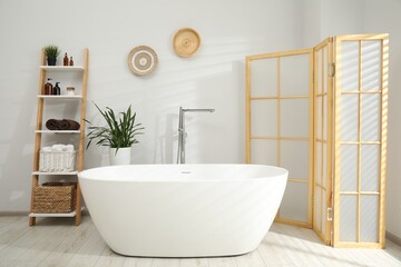 Poster - Stylish bathroom interior with folding screen and tub