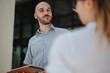 © qunica.com - Business meeting outdoors between two colleagues discussing project details. Professional setting, casual attire, and focused interaction.