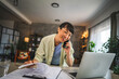© Miljan Živković - Japanese woman with work from home on laptop and talk on mobile phone