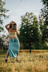 A lovely female dancer gracefully performs modern dance in a sunlit park, capturing a sense of freedom and joy.