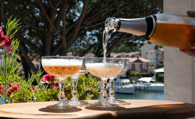 Summer party, French brut rose champagne sparkling wine in coupe glasses in yacht harbour of Port Grimaud near Saint-Tropez, French Riviera vacation, Var, France