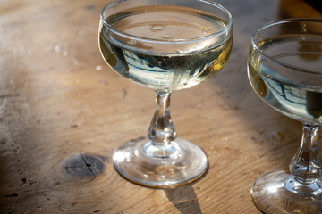 Wall Mural - Sparkling wine, cava or champagne in two coupe glasses on wooden table, French Riviera is summer, France