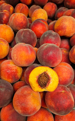 Ripe juicy peaches close-up at a market, natural fruit background