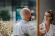 © qunica.com - Two colleagues from a startup team in a business meeting, discussing strategies and brainstorming ideas outdoors.