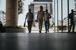 © qunica.com - Three businesspeople walking together in a modern urban downtown, engaged in an outdoor meeting. Concept of teamwork and business professionalism.