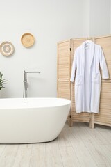 Canvas Print - Stylish bathroom interior with folding screen and tub