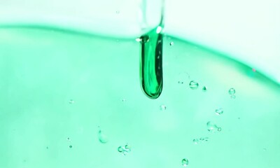 Sticker - Emerald Flow: A captivating macro shot of a viscous, emerald-green liquid cascading in slow motion, forming mesmerizing bubbles and ripples. 