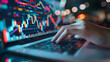 © CNISAK - a pair of hands typing on a laptop, with a background filled with stock market charts and graphs.