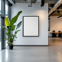 a minimalist office with one large blank picture frame centered on a white wall. the space is empty 