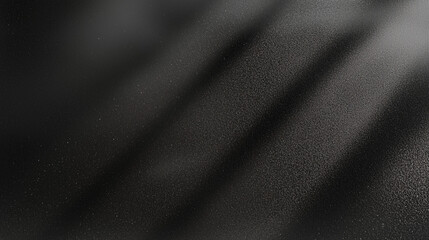 Fototapete - Black matte textured background with floating dust particles illuminated by soft light in the top right corner, creating a deep contrast between black and white. This abstract design emphasizes textur