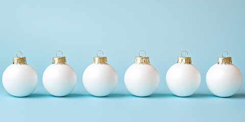 Wall Mural - White Christmas tree bauble ornaments in a row on pastel blue background with copy space