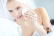 © ReeseBuyout2/peopleimages.com - Skincare, woman and cleaning face with cotton pad for facial hygiene, wipe makeup and dermatology treatment. Girl, product and cosmetic for natural benefits, glow results and beauty mirror at house