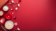 © Tatiana Sdvyzer - Red wellness setup with candles, bath salts, and delicate flowers on a red background for a serene spa atmosphere