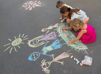 Wall Mural - children draw a family with chalk. Selective focus