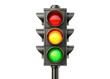 © SNK - A traffic light with a black metal frame and a black pole is positioned against a white backdrop. The lights are circular and display red, yellow, and green. The green light is lit, indicating that tr