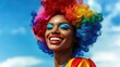 © zhou yan - Celebratory close-up of a joyful African American woman in vibrant clown wig and makeup at a pride parade, showcasing diversity and inclusion against a clear blue sky backdrop, ideal for social awaren