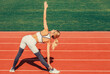 © Yevhen - Healthy woman doing excercise. Sports exercises and stretching in the stadium