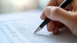 © Mahmud - Headhunter using a pen to tick the correct mark on a resume application form, focusing on screening and selecting the best candidates.