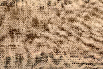 A background of a scratchy burlack material in an even light brown color.