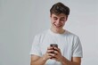© Anjali - Happy young man using smartphone for calls and social media.