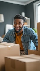 A cheerful young man is unpacking boxes in his new apartment, enjoying the process of moving into a fresh, modern space