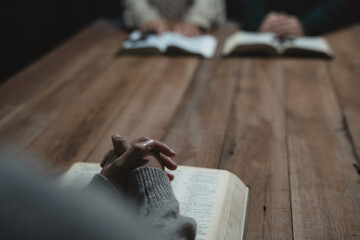 Wall Mural - Asian men and women hands praying to god with the bible. Pray for god blessing. Religious beliefs Christian life crisis prayer to god.